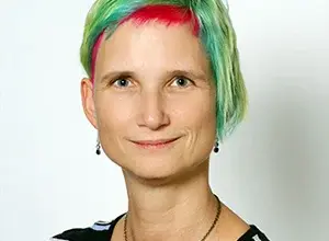 Portrét ženy s barevnými vlasy pro článek o koučování.
