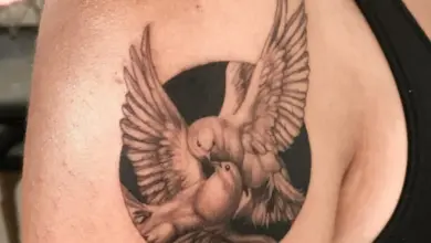 Tattoo of two doves kissing in a circle
