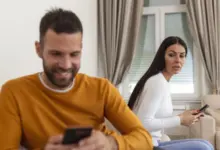 Man and woman on sofa with phones