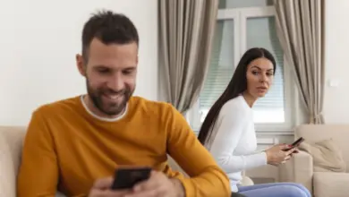Man and woman on sofa with phones