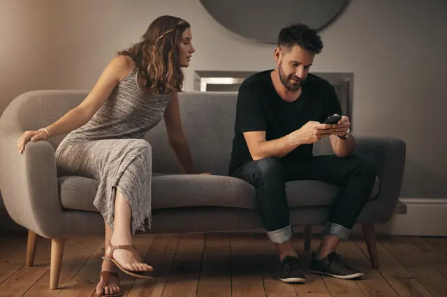 Couple on couch with phone