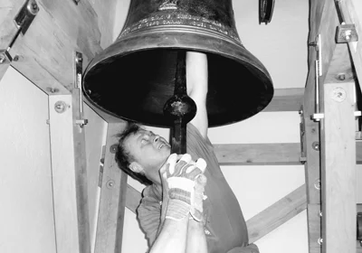 Man ringing church bell