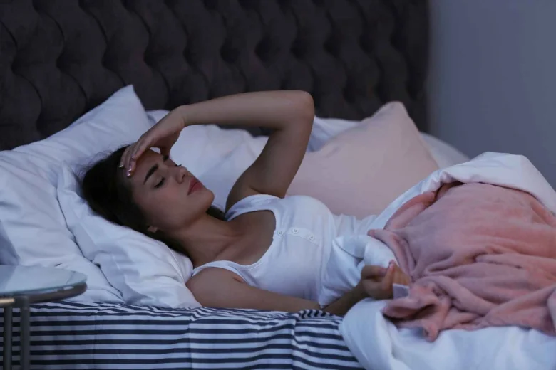 Woman in bed with headache