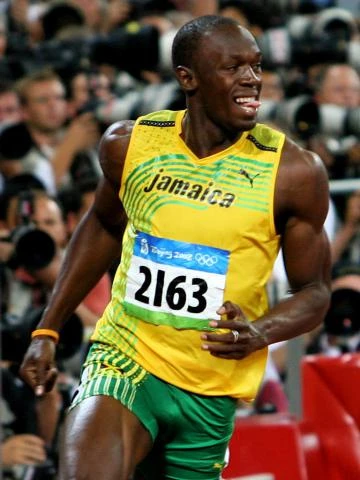 Usain Bolt běží na olympijských hrách v dresu Jamajky.