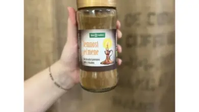 Sklenice s jemným ječmenovým kávou v ruce na pozadí.