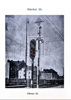 Železniční signál s červenou světelnou částí na koleji.