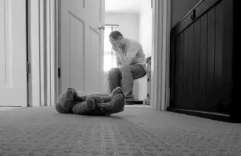 Man sitting with teddy bear