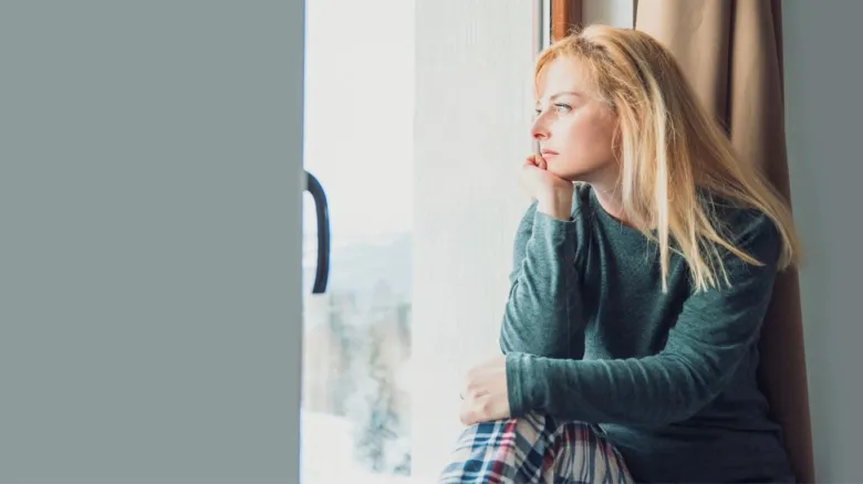 Woman looking out window