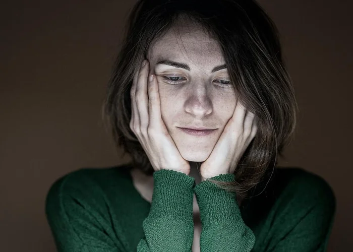 Woman with hands on face