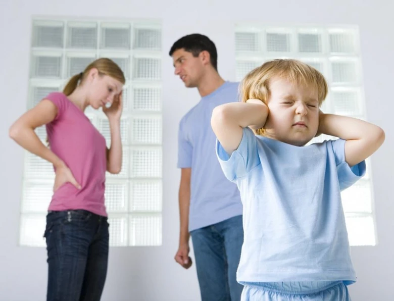 Child blocking ears from parents arguing