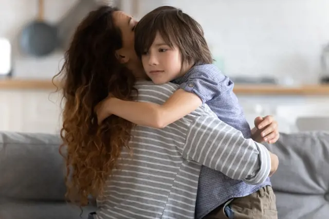 Mother hugging child