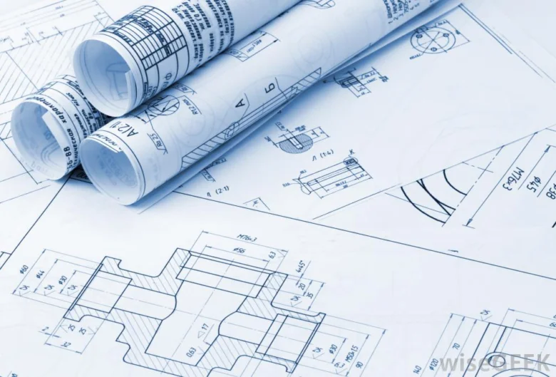 Architektonické plány s technickými detaily na stole.