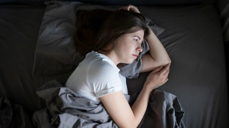 Woman lying in bed alone