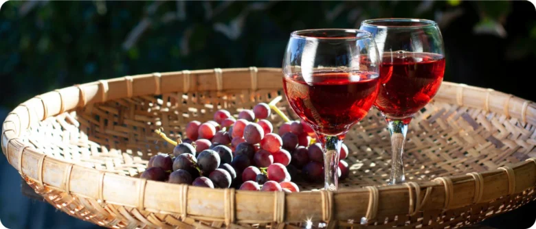 Red wine and grapes in basket
