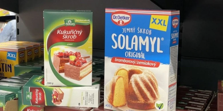 Dva balíčky škrobu - kukuřičného a bramborového - na polici v obchodě.