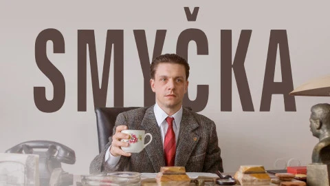 Man holding teacup at desk