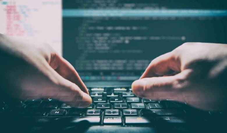 Hands typing on keyboard