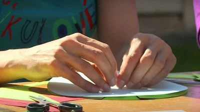 Hands making sundial craft
