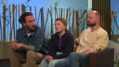 Three people sitting on a couch