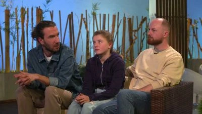 Three people sitting on a couch