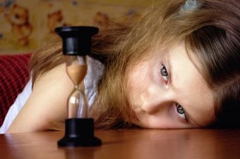 Sad girl with hourglass